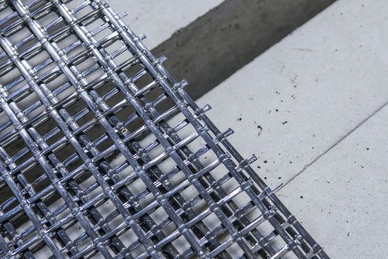 Photo shows a carbon fibre reinforcement in front of concrete